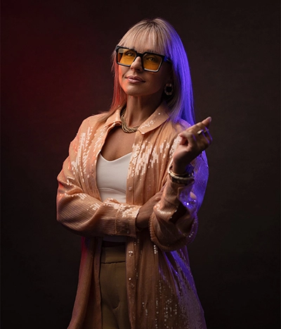 Shooter smarter Mid-torso level headshot of a woman with red and blue light on opposite sides of her