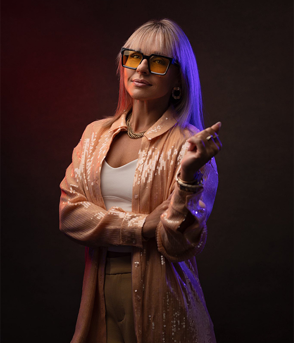 Shooter smarter Mid-torso level headshot of a woman with red and blue light on opposite sides of her