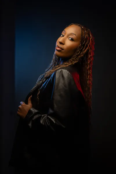 Shooter smarter Mid-torso level headshot of a woman with red and blue light on opposite sides of her